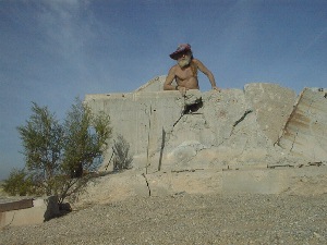 Playing in the sand with blocks of concrete.